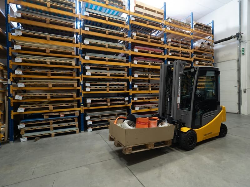 Forklift moving palletised materials in an industrial yard