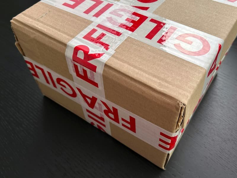 Carefully sealed package marked fragile awaiting controlled transport