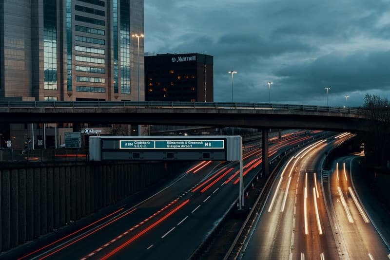 Traffic streaming along a UK motorway as the light fades