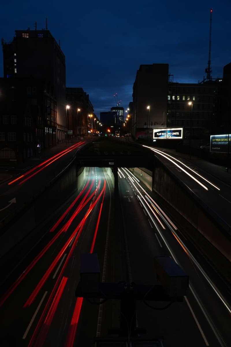 Light trails of night traffic flowing through a UK city underpass