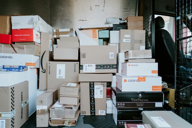 Parcels of every size stacked and sorted inside a courier vehicle